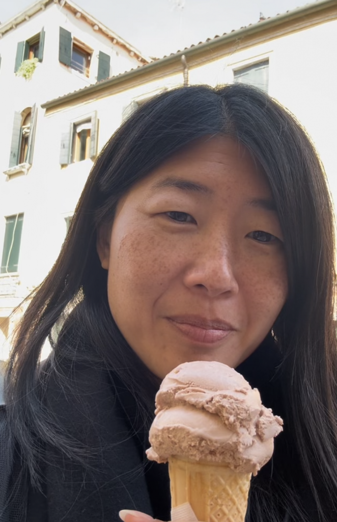 A woman eating an ice cream cone. 